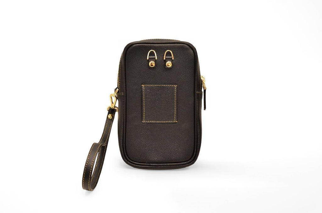 Back view of the camel leather passport holder showing the strap attachment loops and slip pocket