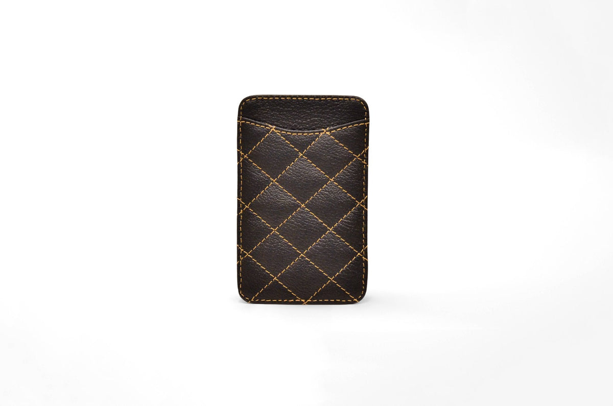 Back view of the black camel leather card holder showing its slim profile and gold stitching